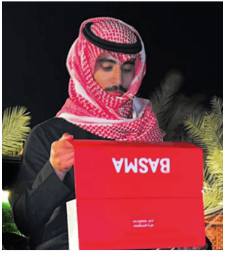 Young Saudi man is holding up the BASMA Aligner Kit.